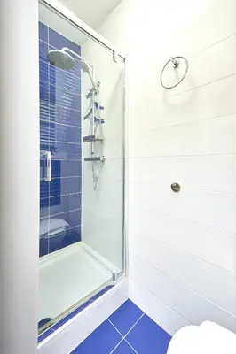 a bathroom with a shower with a glass door at Hotel City Center in Brussels