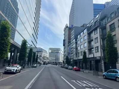 an empty street in a city with cars parked at Hotel City Center in Brussels