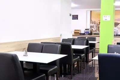 a dining room with tables and black chairs at Hotel City Center in Brussels