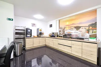 a large kitchen with wooden cabinets and appliances at Hotel City Center in Brussels