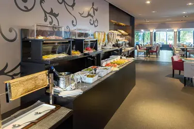 a buffet line in a restaurant with food on display at Martin's Brussels EU in Brussels