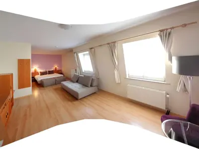 a large living room with a bed and a couch at Hotel La Legende in Brussels