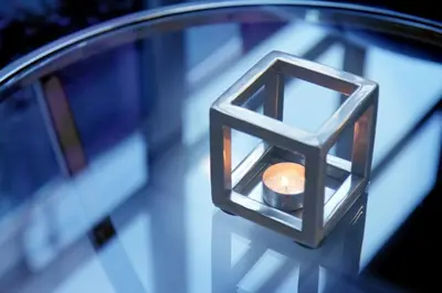 a close up of a candle on a table at Hotel La Legende in Brussels