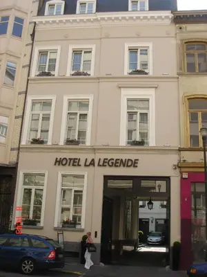 a building with a hotel la leerkende on a street at Hotel La Legende in Brussels