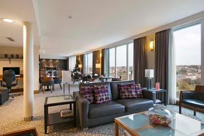 a living room with a couch and a table at Crowne Plaza Brussels Airport by IHG in Zaventem