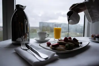 a plate of food and a bottle of orange juice at Crowne Plaza Brussels Airport by IHG in Zaventem