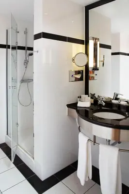 a bathroom with a sink and a shower at Crowne Plaza Brussels Airport by IHG in Zaventem