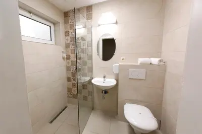 a bathroom with a toilet and a sink and a mirror at Hotel de France in Brussels