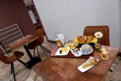 a table with a tray of breakfast food on it at Hotel de France in Brussels
