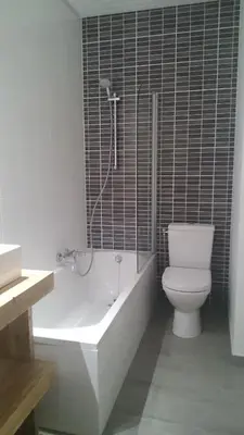 a bathroom with a toilet and a tub and a shower at Hotel Panorama in Overijse