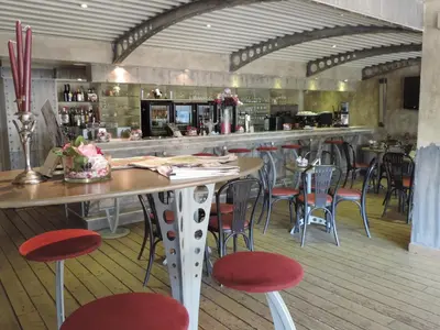 a restaurant with a bar with tables and chairs at Hotel Panorama in Overijse