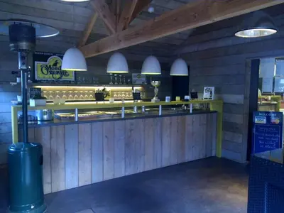 a bar in a restaurant with wooden walls at Hotel Panorama in Overijse