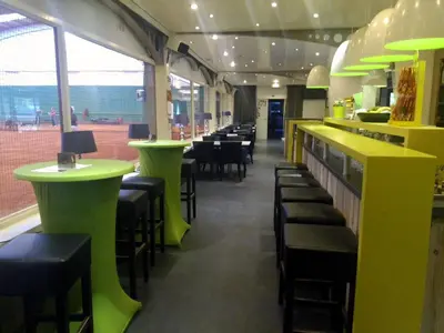 a dining room with green tables and chairs at Hotel Panorama in Overijse
