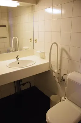 a bathroom with a sink and a toilet and a mirror at City Apartments Antwerpen in Antwerp