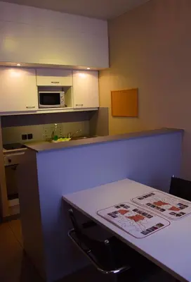 a kitchen with a counter and a table and a microwave at City Apartments Antwerpen in Antwerp