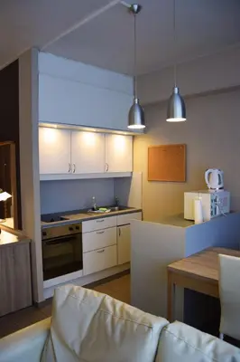 a kitchen with a couch and a table in a room at City Apartments Antwerpen in Antwerp