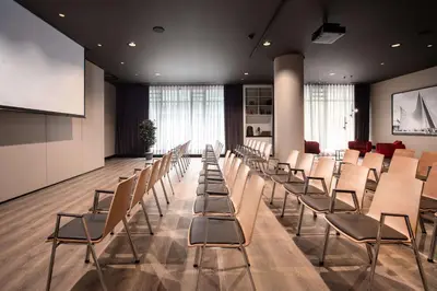 a conference room with chairs and a projection screen at Radisson Collection Grand Place Brussels in Brussels