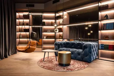a living room with a blue couch and a table at Radisson Collection Grand Place Brussels in Brussels