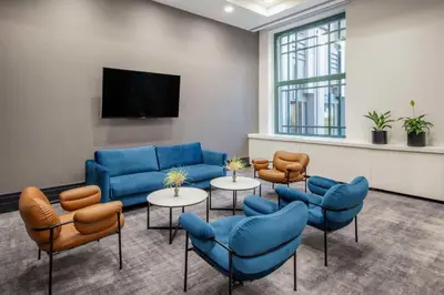 a waiting room with blue couches and chairs at Radisson Collection Grand Place Brussels in Brussels