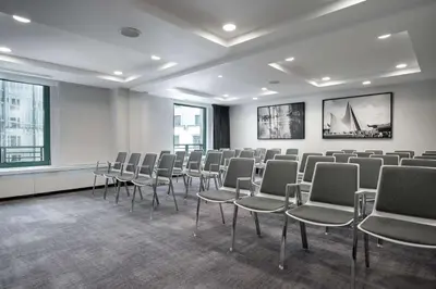 a room with rows of chairs in front of a wall at Radisson Collection Grand Place Brussels in Brussels