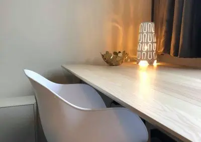 a desk with two white chairs and a wooden table at Apartments Business Flats Brussels Airport in Zaventem