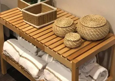 three straw hats sitting on a wooden table at Apartments Business Flats Brussels Airport in Zaventem