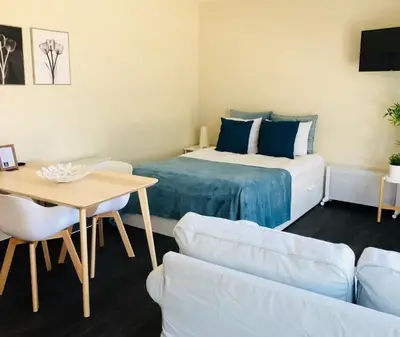 a room with a bed and a table and a couch at Apartments Business Flats Brussels Airport in Zaventem