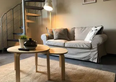 a living room with a couch and a table at Apartments Business Flats Brussels Airport in Zaventem