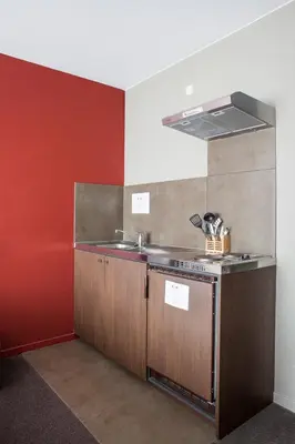 a kitchen with a sink and a counter top at Hotel Rastelli Tervuren in Tervuren