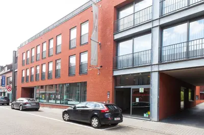 a black car parked in front of a brick building at Hotel Rastelli Tervuren in Tervuren