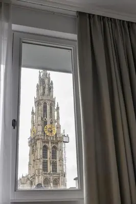 a view of a clock tower from a window at Hotel Rubens-Grote Markt in Antwerp