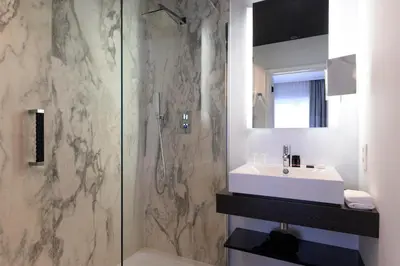 a bathroom with a sink and a shower at Hotel Rubens-Grote Markt in Antwerp