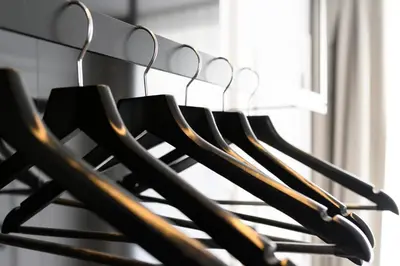 a bunch of black shirts hanging on a rack at Hotel Rubens-Grote Markt in Antwerp