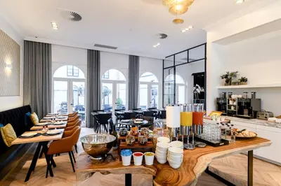 a dining room with a long table and chairs at Hotel Rubens-Grote Markt in Antwerp