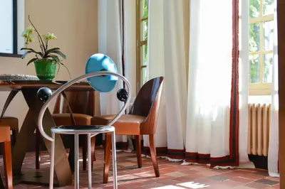 a table and chairs in a room with a desk at B&B The Verhaegen in Ghent