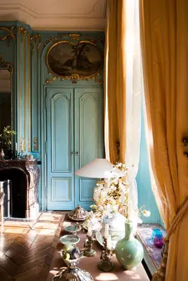 a room with blue walls and a table with vases at B&B The Verhaegen in Ghent