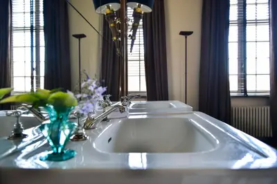 a bathroom sink with a vase on top of it at B&B The Verhaegen in Ghent