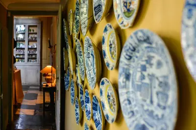 a wall with blue and white plates on a wall at B&B The Verhaegen in Ghent