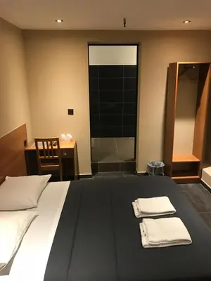 a bedroom with a bed with two towels on it at Royal Hotel in Brussels