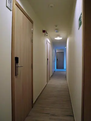 a hallway of an office building with a row of doors at Hotel Ladeuze in Leuven
