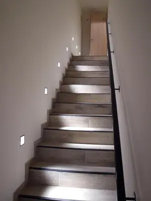 a stairwell with wooden steps and a door at Hotel Ladeuze in Leuven
