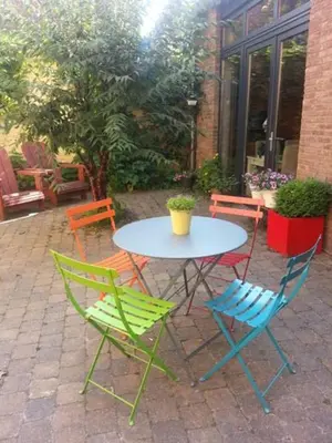 a table with four chairs and a table with at Hotel Ladeuze in Leuven