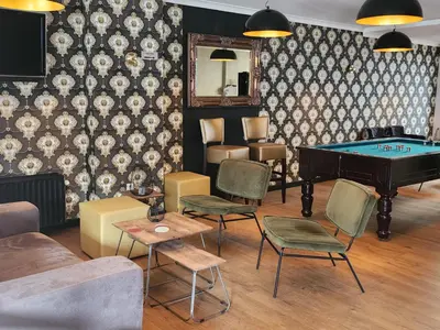 a living room with a pool table and chairs at Hotel Royal Zelzate in Zelzate