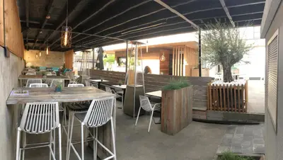 a restaurant with chairs and a table and a bar at De Heidebloem in Zoersel