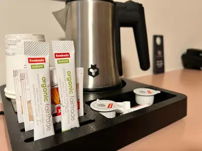 a counter top with a coffee pot and paper cups at De Heidebloem in Zoersel