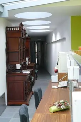 an office with a long wooden table and chairs at Aparthotel Malpertuus in Aalst