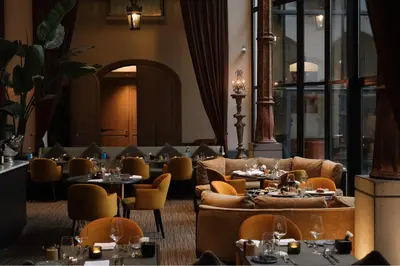 a restaurant with couches and tables and chairs at The Dominican, Brussels, a Member of Design Hotels in Brussels
