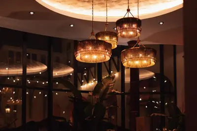 a group of chandeliers hanging from a ceiling at The Dominican, Brussels, a Member of Design Hotels in Brussels