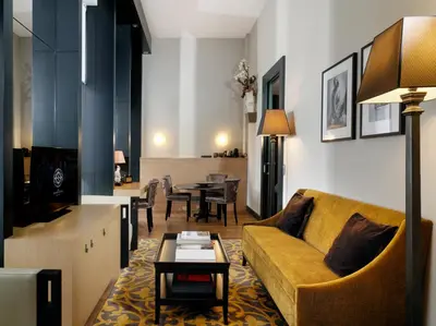 a living room with a couch and a table at The Dominican, Brussels, a Member of Design Hotels in Brussels