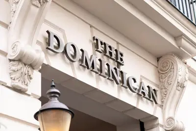 a sign on the front of a building with a street light at The Dominican, Brussels, a Member of Design Hotels in Brussels